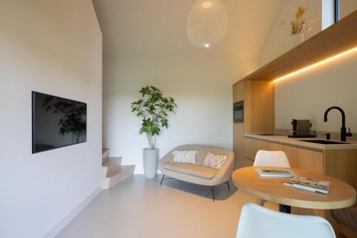 a living room with a table and a chair at Guesthouse 'Elements' with panoramic views in Bergen
