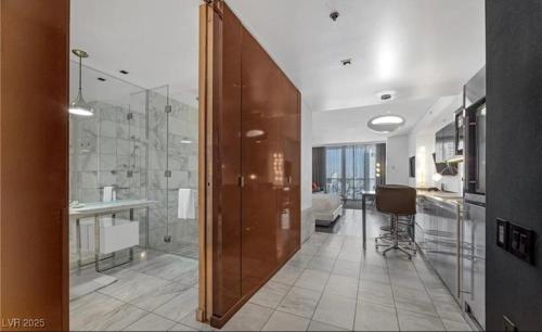 a bathroom with a shower and a sink and a toilet at Justin's at Palms Place in Las Vegas