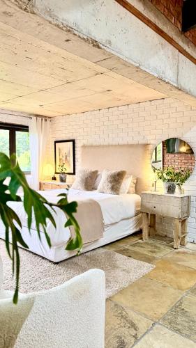 a bedroom with a large bed and a table at 007 Loft in Mossel Bay