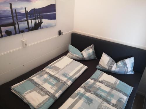 a room with two beds and pillows on the floor at Meerblick 1 in Sierksdorf