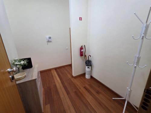 a white room with a door and a wooden floor at Penthouse Quinta Village Garajau in Caniço
