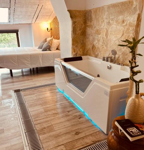 a bath tub in a living room with a bed at El Pico de Aroche in Aroche