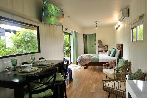 a room with a dining table and a living room at Volcano Garden Suite with Hottub in Palma
