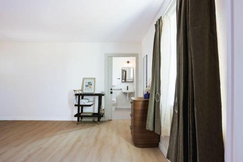 a living room with white walls and a wooden floor at Salt Ranch Hotel in Nashville