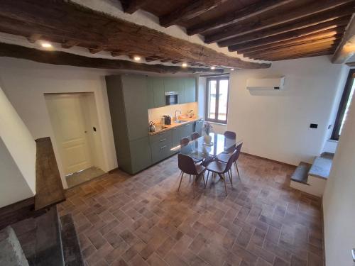 a kitchen and dining room with a table and chairs at Palazzo Bottino in Bolsena