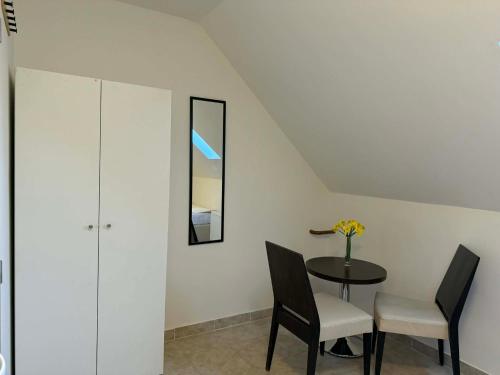 a dining room with a table and two chairs at Ubytovna u Maiky in Libochovice