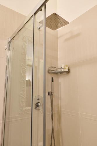 a shower in a bathroom with a glass shower stall at Tiare' in Trani