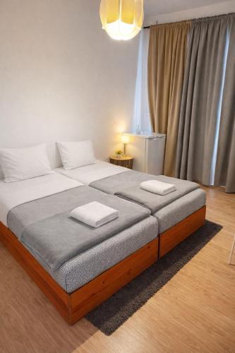 a bedroom with a large bed with two towels on it at Vikap Guest House in Porto