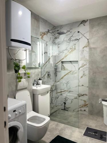 a bathroom with a toilet and a sink and a shower at Relax Visoko Apartman in Visoko