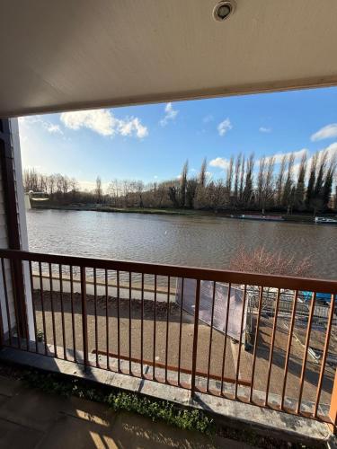 a view of a river from a balcony at Elegant 1-Bedroom Flat With Stunning Thames views in Kingston upon Thames