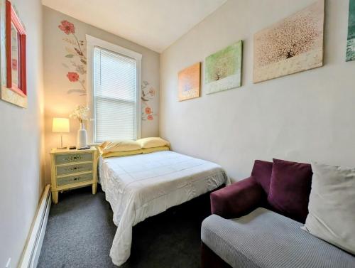 a small bedroom with a bed and a couch at The Avondale Guesthouse in Chicago