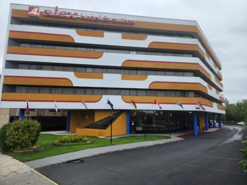 a large building with flags in front of it at Alex Hotel and Suites Anchorage Airport in Anchorage