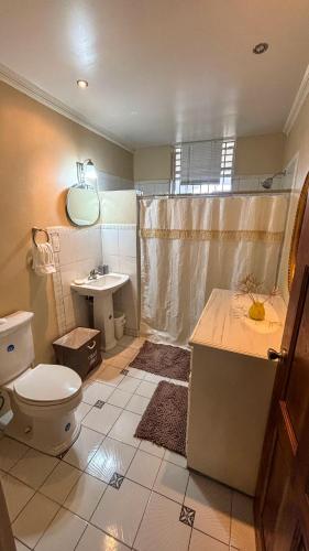 a bathroom with a toilet and a sink at 1 Bed Apt overlooking Rodney Bay in Gros Islet