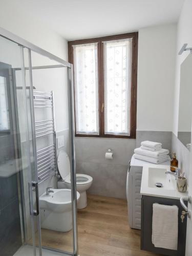 a bathroom with a toilet and a sink and a shower at Oasi Bernareggio Smart Work & Relax in Bernareggio