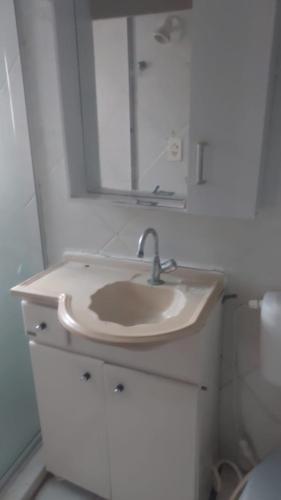 a bathroom with a sink and a mirror at Casa de Mainha in Salvador