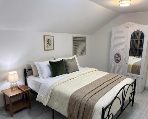 a bedroom with a large bed and a table at LKL appartements in Kinshasa