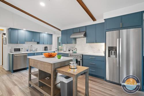 a kitchen with blue cabinets and stainless steel appliances at Pet-Friendly Lake Como Retreat 2BR in Lake Geneva