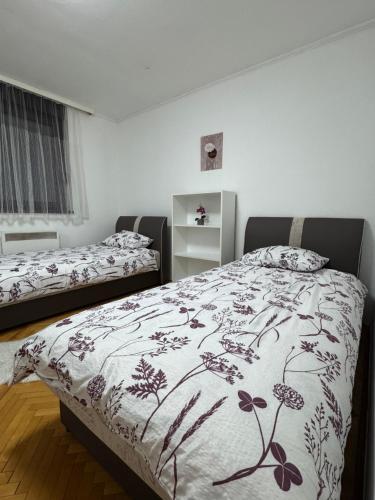 a bedroom with two beds with a blanket on it at Apartman 7 Foča in Foča