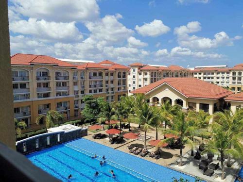a view of a resort with a swimming pool at Hanna's Condo at Sanremo Oasis in Cebu City