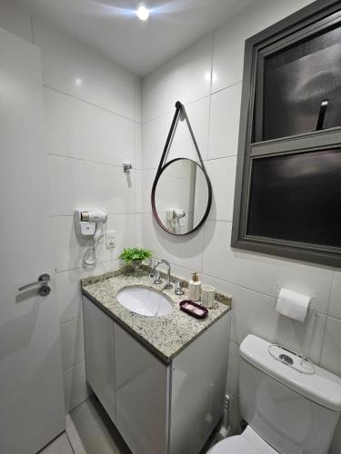 a white bathroom with a sink and a mirror at Studio Itaú Metrô Conceição in São Paulo