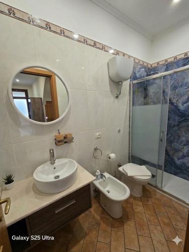a bathroom with a sink and a toilet and a mirror at Dimora Sogno Suite in Termoli