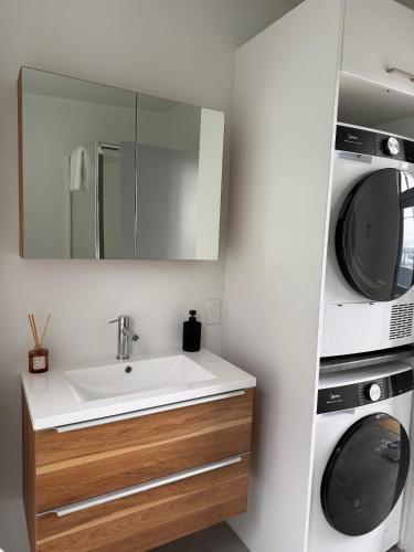 a bathroom with a sink and a microwave at Stylish Private Apartment, Close to Ferry, Stadium, Parking in Wellington