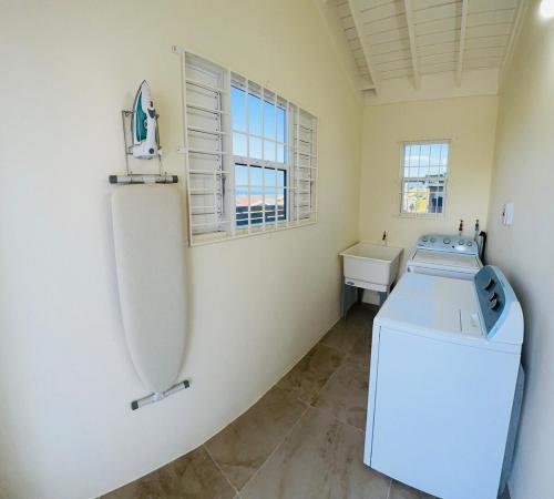a kitchen with a white refrigerator and a sink at Escape Beloved in Florence Hall