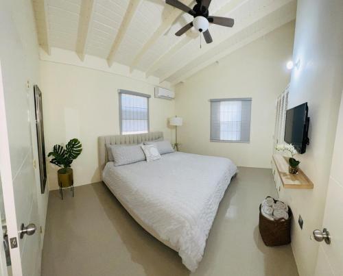 a bedroom with a bed and a ceiling fan at Escape Beloved in Florence Hall