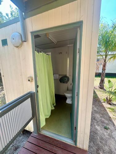 a bathroom with a toilet inside of a house at River Bend Caravan Park in Kanyapella