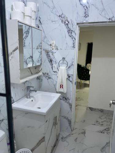 a white bathroom with a sink and a mirror at Villa Rivera in Boca Chica
