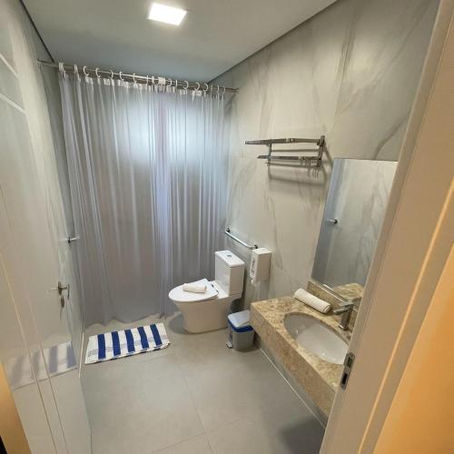 a bathroom with a shower and a toilet and a sink at Hotel La Roza e Restaurante Grill in Penha