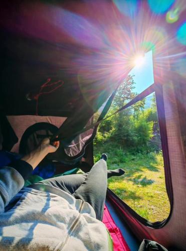 a person sitting in a tent looking out the window at 4x4 RoofTent Camper Offroad in Tirana