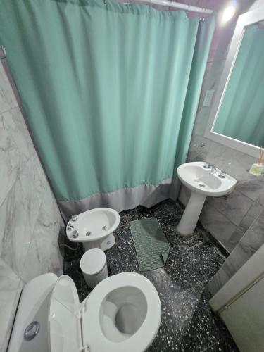 a bathroom with a toilet and a sink at Casa Blanca Verónica in Veronica