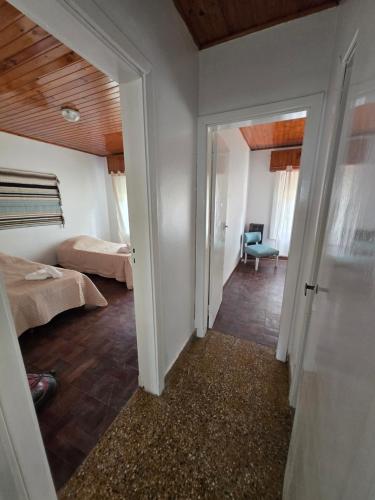 a room with a room with two beds and a hallway at Casa Blanca Verónica in Veronica