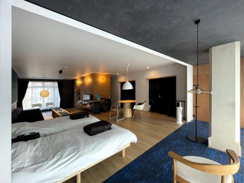 a bedroom with a bed and a living room at 古街のアトリエ in Utazu