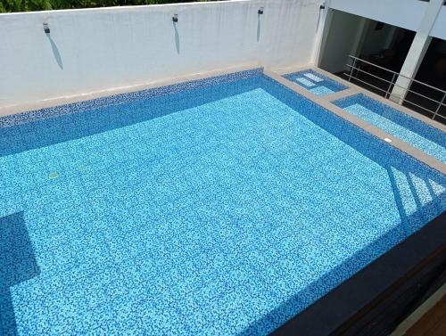 a large swimming pool with blue tiles on it at Michaels Spring Resort, Natural Hot Spring in Calamba