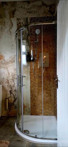a shower with a glass door in a bathroom at Dabbagh Residence in Lees