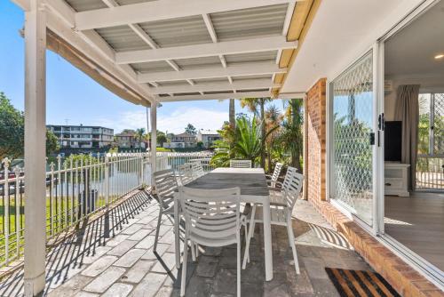 a patio with a table and chairs on a balcony at Family Friendly 2 Bed Flat with Balcony in Mooloolaba