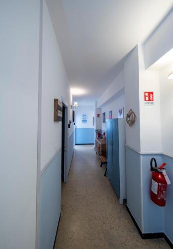 a hallway with blue and white walls and a room at Pippo a Vernazza Rooms in Vernazza