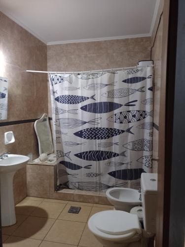 a bathroom with two toilets and a shower curtain at CASA QUINTA Sasha in Sauce Viejo