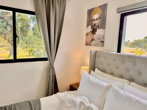 a bedroom with a bed and a window with a picture at Punta Cana Retreat in Punta Cana