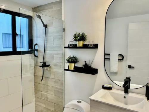 a bathroom with a shower and a sink and a mirror at Punta Cana Retreat in Punta Cana