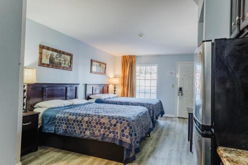 a hotel room with two beds and a television at Jackson Town House Inn in Jackson