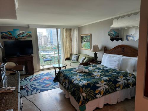 a hotel room with a bed and a couch at Luana Waikiki in Honolulu