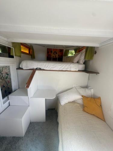 a small room with a bed and a couch at Surf Shack on Broadway in Waitara