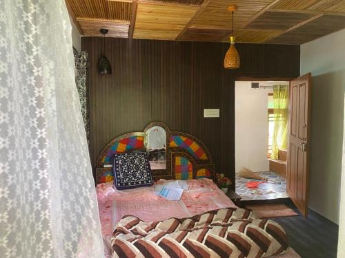 a bedroom with a bed and a mirror at Scenic Mountain Hut Naranag in Kangan