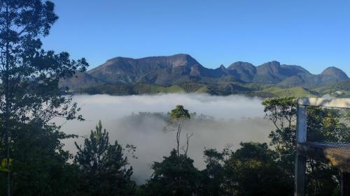 a view of a misty lake with mountains in the background at Fazenda Vista Soberba in Nova Friburgo