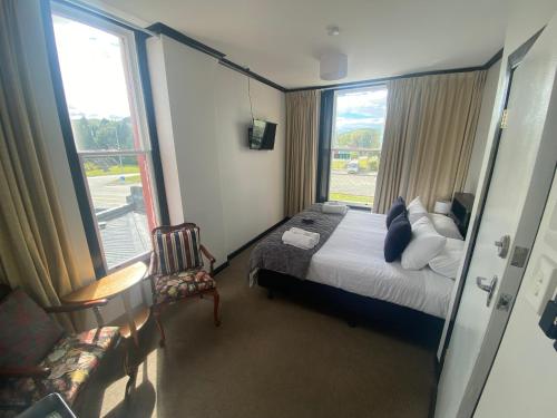 a hotel room with a bed and a window at The Old Railway Hotel Lumsden in Lumsden