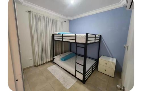 a small room with two bunk beds in it at Pine Tree Entire House 2B Gated Com in Higuey