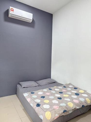 a bedroom with a bed and a air conditioner at Homestay Sri Aman in Simanggang